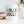 Load image into Gallery viewer, A white ceramic coffee mug with the vibrant, bold words HOLLY JOLLY printed in hues of red and green in a modern, trendy, fun, and festive font.
