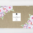 Load image into Gallery viewer, Rustic lavender roses paper placemats with purple flowers and faux linen design, perfect for modern table settings.