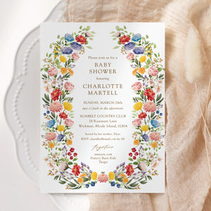 Colorful wildflower baby shower invitation card for garden theme celebration, blending purple, green, yellow, and pink florals, perfect for spring or summer boho-themed baby showers.