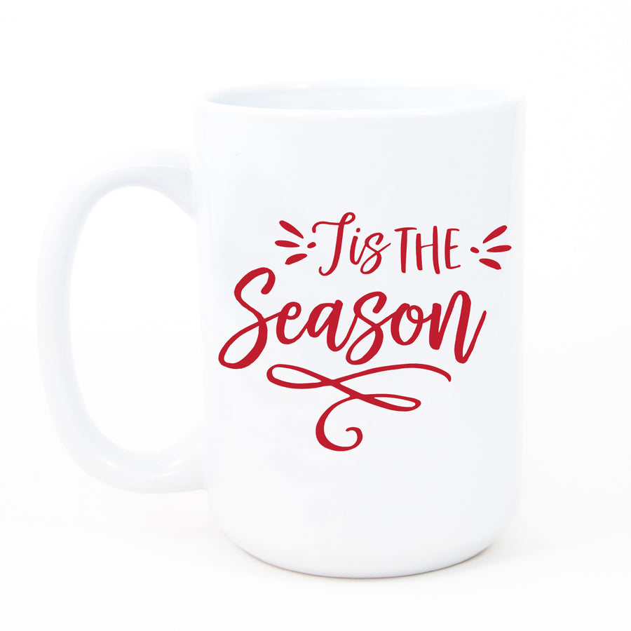 Tis the Season Coffee Mug by Digibuddha, featuring 'tis the season written in red festive script on a white glossy ceramic mug.