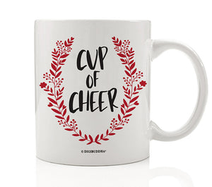 Cup of Cheer Coffee Mug with bold black festive text and a red wreath Christmas emblem on a fine white ceramic mug.