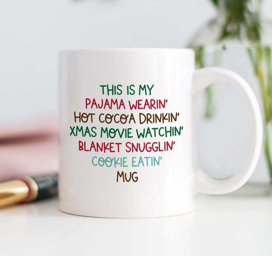Vibrant and fun Christmas mug with humorous text in festive hues of reds, greens, browns, and blues, perfect for movie lovers and hot cocoa drinkers.