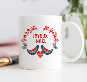 Joyeux Noel Christmas mug with red floral pattern, Christmas cardinals, wreath, and joyeux noel message