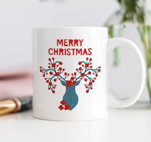 Close-up image of a Merry Christmas winter berries coffee mug by Digibuddha, showcasing its festive design with elegant red winter berries.