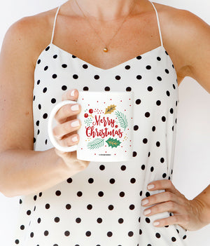 Vibrant red, white, and green Merry Christmas Holly Coffee Mug with a modern design of holly and evergreen, a perfect Christmas coffee mugs from Digibuddha.