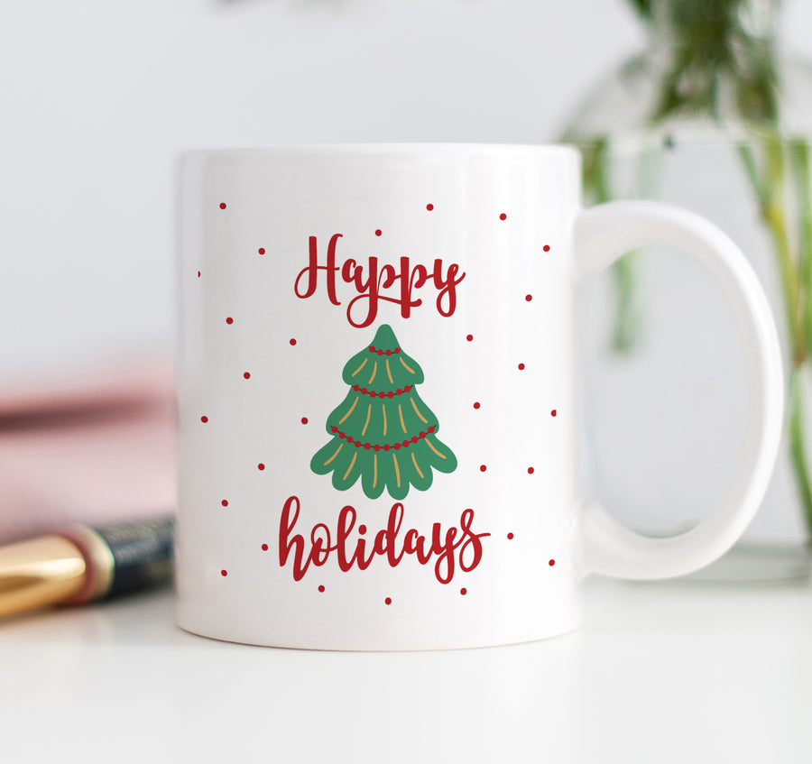 A festive Happy Holidays coffee mug featuring a vibrant Christmas tree graphic and bold red lettering, perfect for the holiday season.