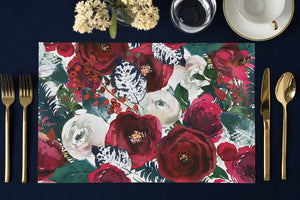 Elegant Digibuddha paper placemats showcasing a vibrant floral pattern with blooming red and white roses against a deep Christmas red backdrop. The professionally press printed, luxury placemats, measuring approximately 17x11 inches