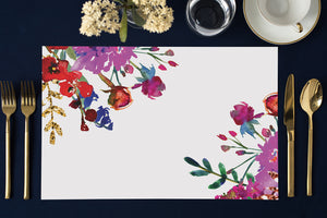 Vibrant purple and pink floral paper placemats, ideal for modern dining, bridal showers, and chic outdoor table settings.
