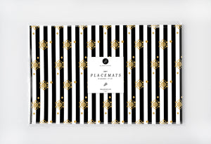 Elegant black and white striped placemat adorned with gold snowflakes and glitter like details.