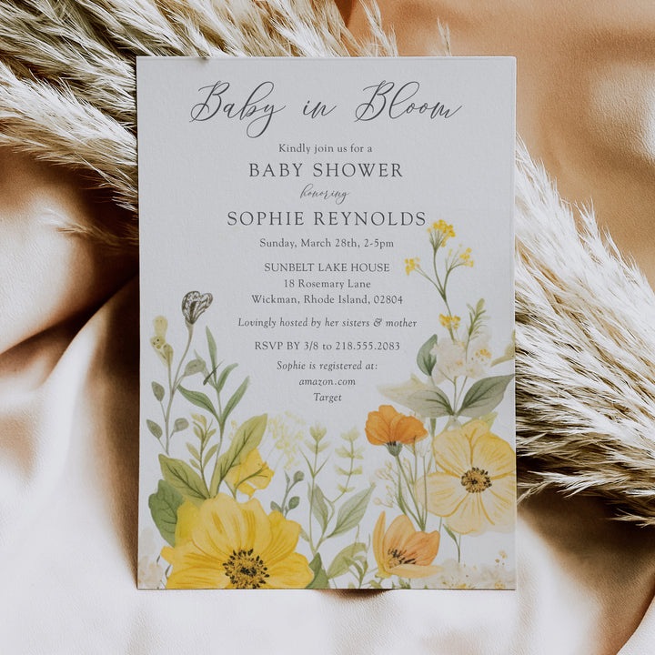 Baby in bloom shower invitation featuring yellow wildflowers, pastel hues, and sage green accents for a whimsical, gender-neutral celebration.