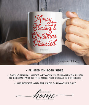 A white ceramic Christmas mug with Merry Blessed & Christmas Obsessed printed in red, festive script. Perfectly embodies the obsessed with Christmas spirit.