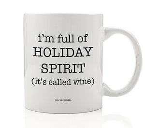 A white ceramic coffee mug with I'm Full of Holiday Spirit It's Called Wine printed in playful, modern font.