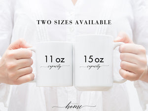 A white ceramic coffee mug with I'm Full of Holiday Spirit It's Called Wine printed in playful, modern font.