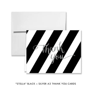 Elegant glam black and silver bridal shower invitation with black and white stripes and silver glitter.